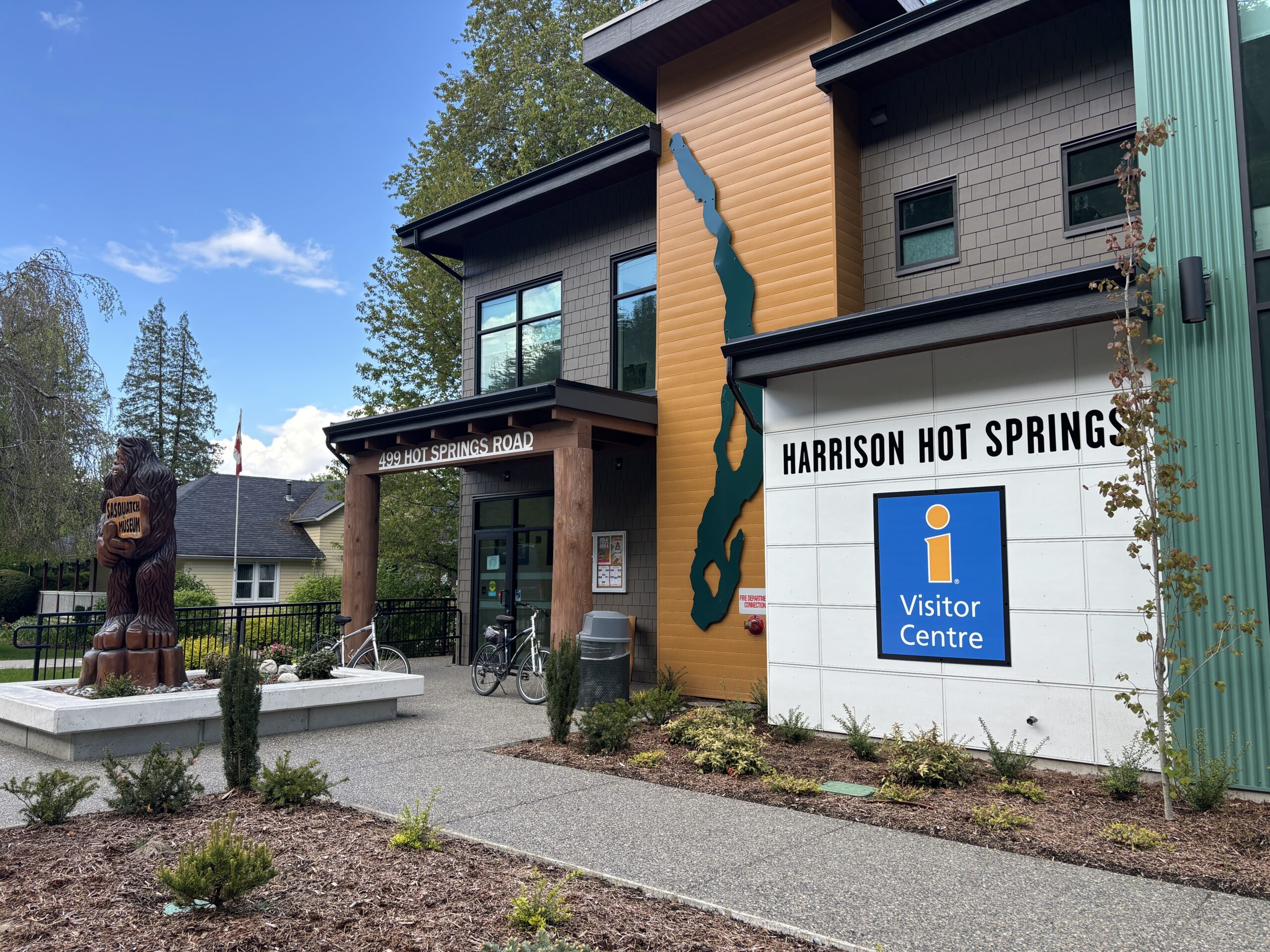 The front of a tourism building, with signage that says "Harrison Hot Springs"