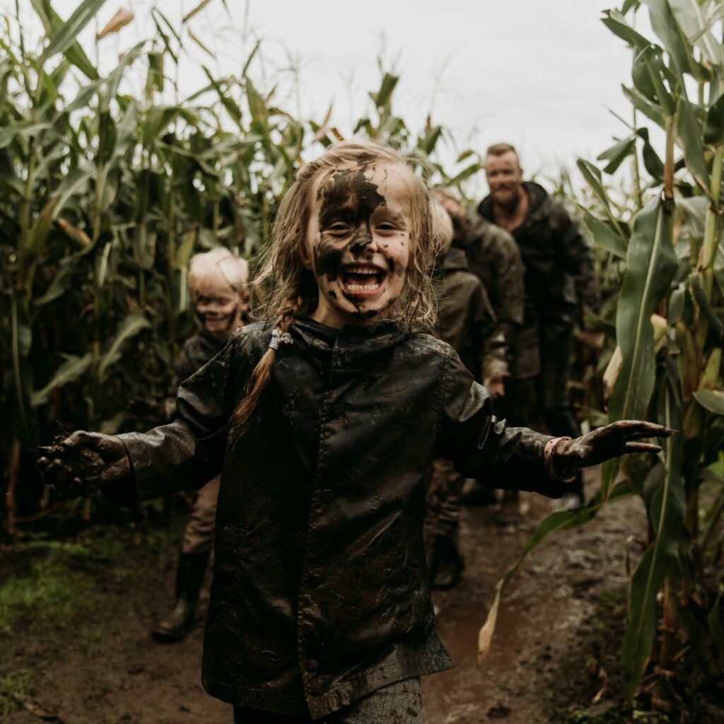 family runs in mud maze