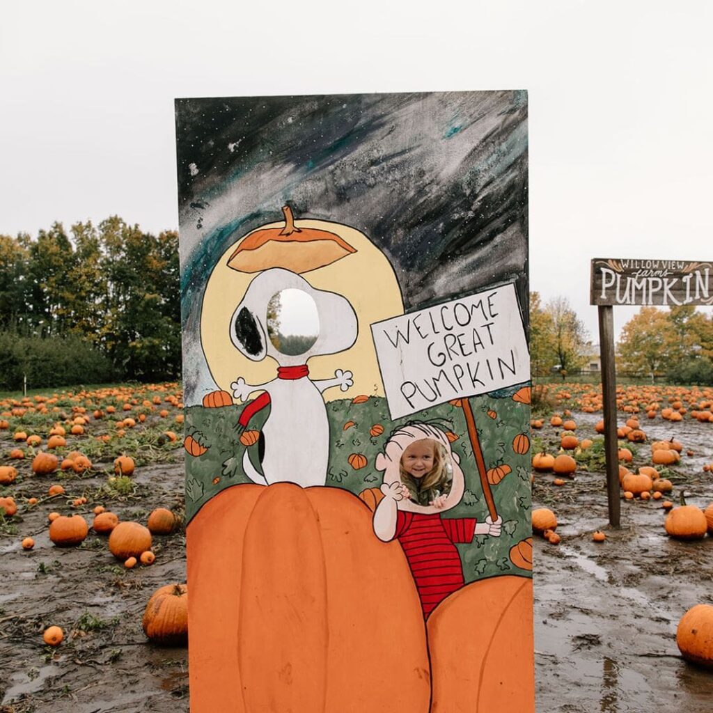 child with snoopy halloween sign