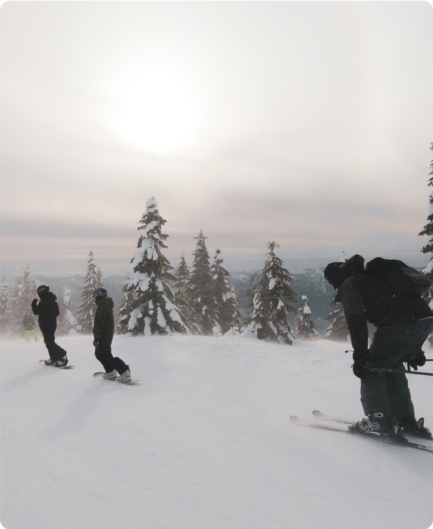 Snowboarders And Skier